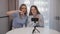 Girls recording positive vlog video speaking to webcam smartphone at home.