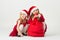 Girls in a red dress in the bell Santa Claus sitting