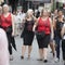 Girls in red T-shirts walk on the street at the hens party