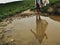 Girls reflection in the mud