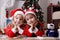 Girls Santa helpers lying under Christmas tree