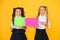Girls school uniform hold poster. Visual communication concept. School friendship. School girls show poster
