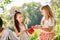 Girls share their food at a picnic