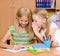 Girls sharing secrets in classroom