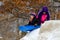 Girls sledding on a hill