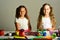 Girls with smiling faces by their art desk