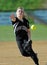 Girls softball - pitcher delivers a pitch