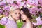 Girls in spring flowers. Fashion cosmetics and perfumes.