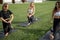 Girls stretching before sports training on lawn