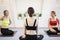 Girls stretching and talking between yoga exercises. Instructor and two students