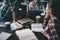 Girls students drinking coffee and studying together at table