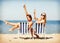 Girls sunbathing on the beach chairs