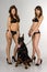 Girls in swimsuit with Doberman on white backgro