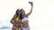 Girls taking selfie using phone on beach smiling. Hug each other
