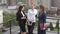 Girls are talking on the roof. Three attractive friends gossip and chat during a break at work. slow motion