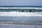 Girls in thermal overalls swim on the boards in the Northwest Pacific