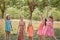 Girls throw up confetti at a children`s party in a summer Park.