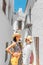 Girls tourist admiring great view of flowerpots on the white walls on famous Flower street in Andalusia