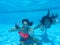 Girls underwater in pool