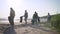 Girls volunteers clean the coastline from garbage. Women stack the garbage washed ashore in black bags. Ecological