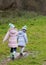 Girls walking through a muddy puddle