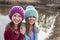 Girls wearing crocheted hats by pond