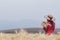 The girls wore red vintage dresses that were blessed above the golden barley fields in the morning alone