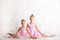 Girls - young ballerinas in pink dresses on a light background