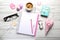 Girly accessories with notebook, cup of coffee and gift box on w