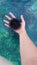 In the girlâ€™s hand is a large black sea urchin, in the beautiful water of the Adriatic