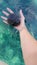 In the girlâ€™s hand is a large black sea urchin, in the beautiful water of the Adriatic