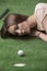 Girlâ€™s lying on grass with golf ball