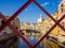 Girona`s tipical skyline cityscape through the frame of red iron bridge over the Onyar River