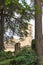 Girona, Spain, August 2018. View of the bell tower of the Catholic Cathedral through the trees of the park.