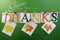 Give Thanks message hanging from pegs on a line for Thanksgiving greeting with leaves