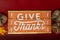 Give Thanks text phrase Thanksgiving holiday background with pumpkins