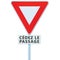 Give way yield french cÃ©dez le passage road sign, France, isolated vertical macro closeup, white signage triangle red frame