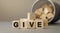 Give - word concept from wooden blocks on desk