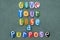 Give your life a purpose, motivational phrase composed with multi colored stone letters on the sand