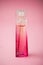 Givenchy irresistible perfume in a miniature bottle on pink background
