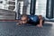 Giving all his best. Handsome young African man in sport clothing doing push-ups while exercising in the gym