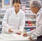 Giving every client extra special care. a young pharmacist helping an elderly customer at the prescription counter.