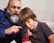 Giving him a detailed history on the railroad. a grandfather showing his grandson a toy train.