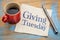 Giving Tuesday concept on napkin with coffee