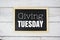 Giving Tuesday text on blackboard flat lay on wooden background