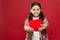Giving you her heart. Cute girl in love. Little girl holding big red heart. Little child expressing love on valentines
