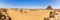 Giza desert panorama with camels and pyramids, Egypt