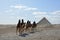 GIZA/EGYPT, NOVEMBER 30, 2018: a desert and several hills next to the pyramids, with people and camels