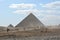 GIZA/EGYPT, NOVEMBER 30, 2018: two pyramids, people and camels in the desert, with clouds