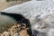 Glacial lake of melting ice of glacier and rocks in Summer. Partially frozen. Landscape scene in Aosta Valley in Italy. Climate